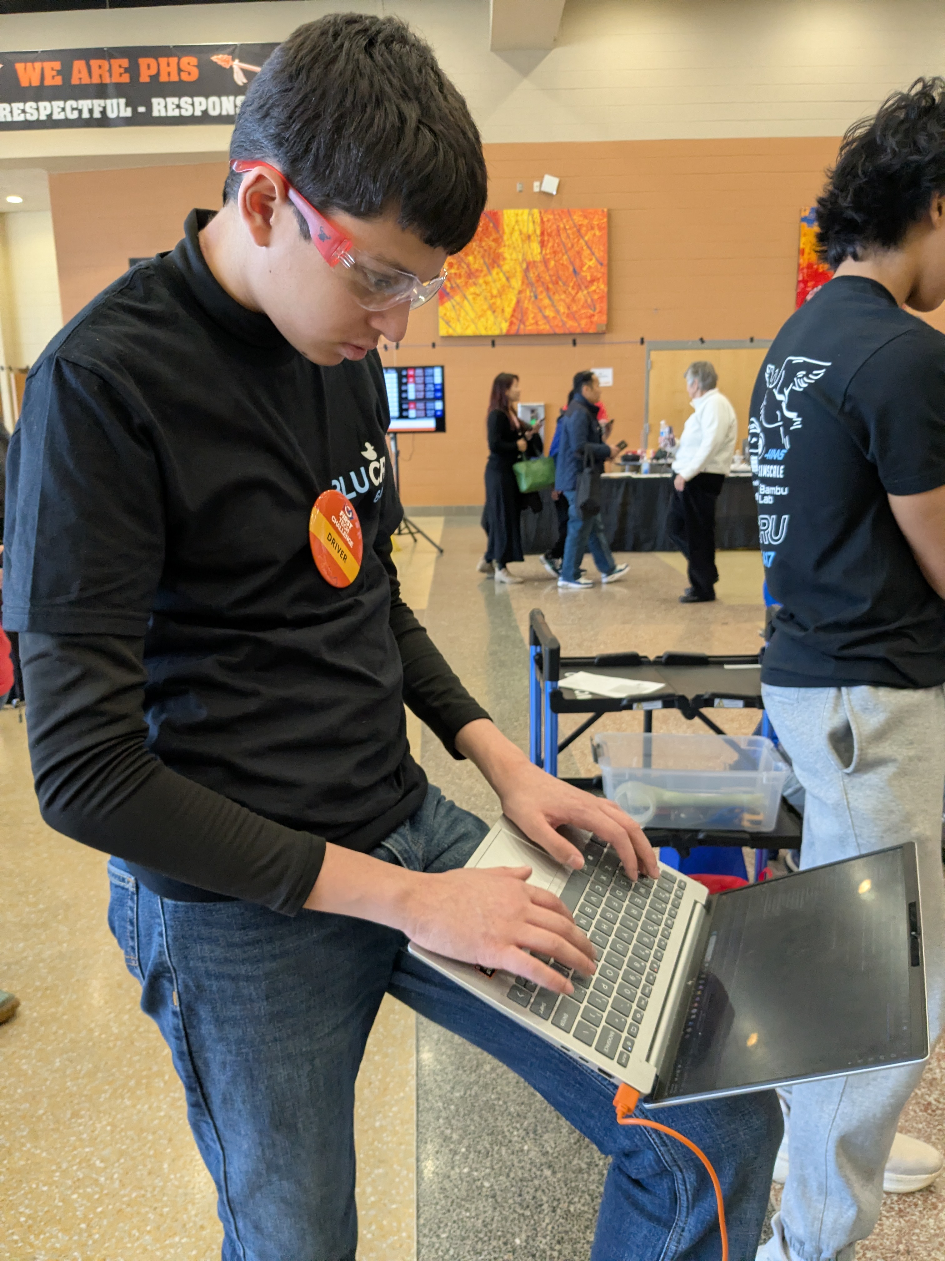 Deven working on laptop at competition