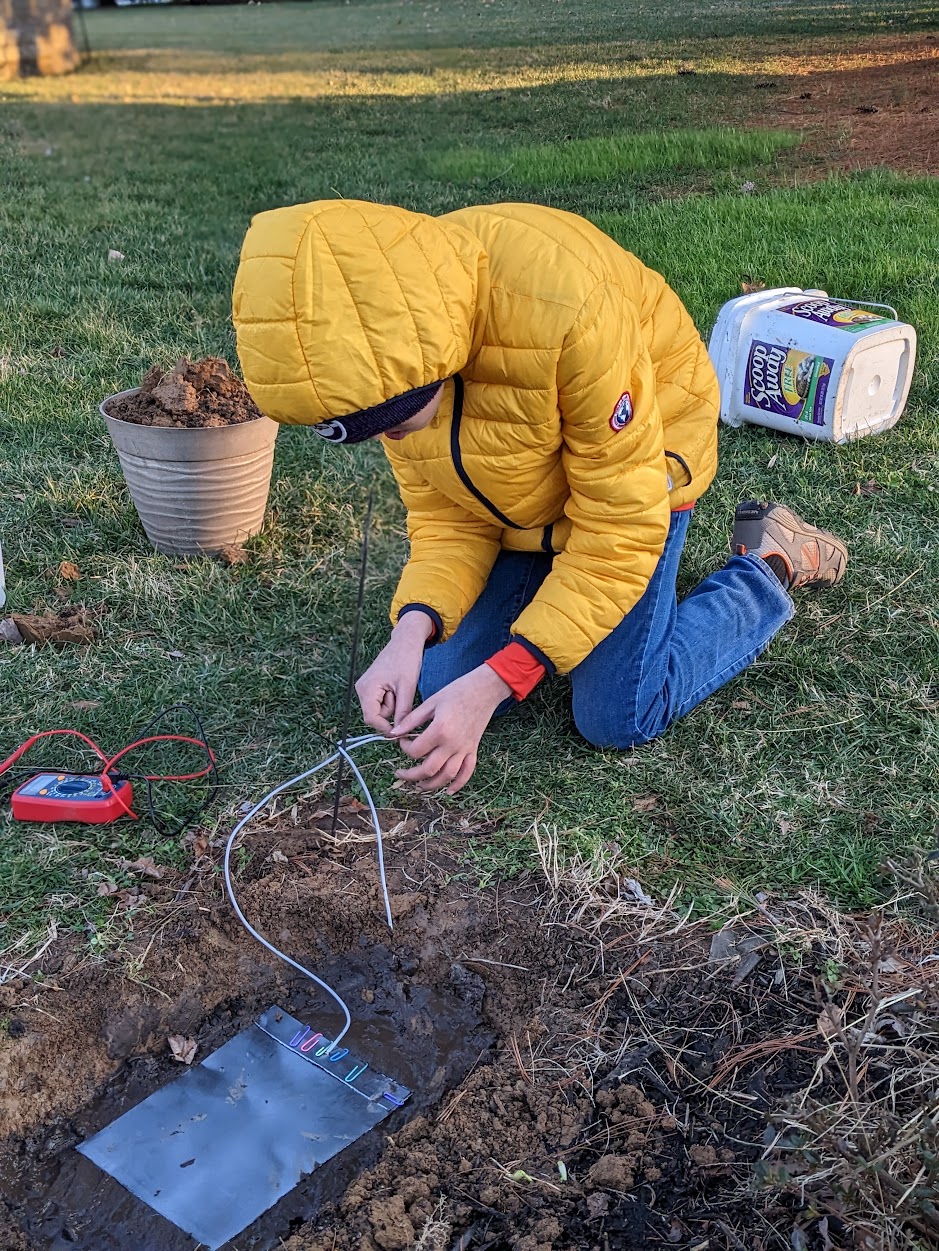 Collecting soil samples and taking measurements outdoors